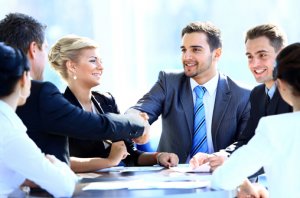 Two business colleagues shaking hands during meeting